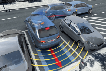 Technician installing parking sensors on a car